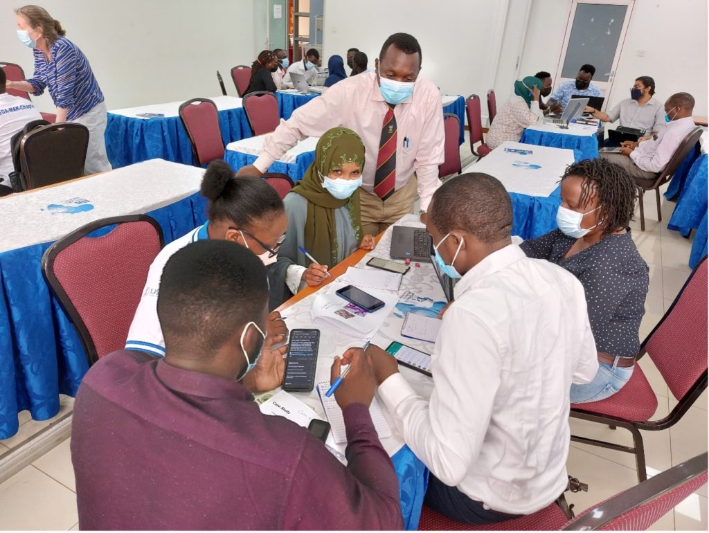 Small group of One Health practitioners working through a scenario facilitated by Dr. Robert Lukande. 